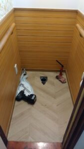 比企郡吉見町のトイレ交換工事で既設便器を撤去し排水接続部を確認している様子